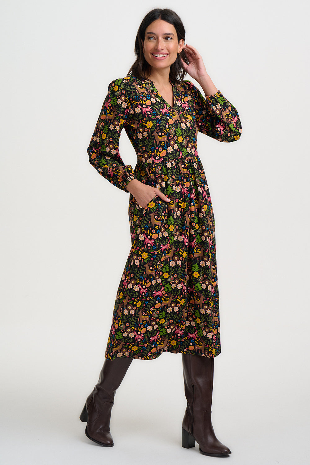 Woman wearing a floral dress with long sleeves on a white background