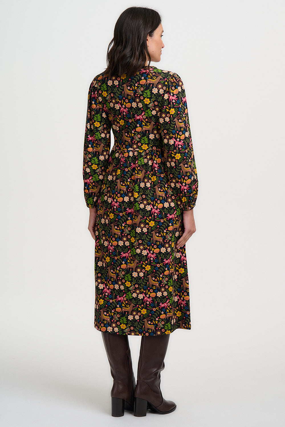 Woman wearing a long floral dress on a white background