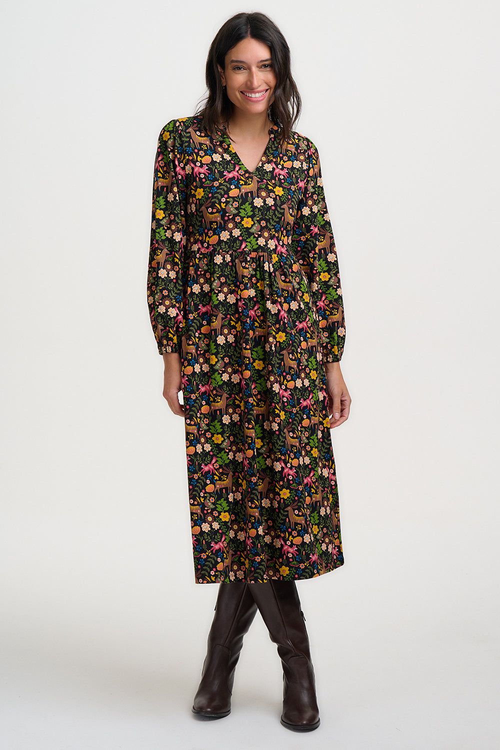 Woman wearing a floral dress with long sleeves on a white background