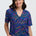 Woman wearing a colorful patterned shirt and pants on a white background