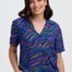 Woman wearing a colorful patterned shirt and pants on a white background