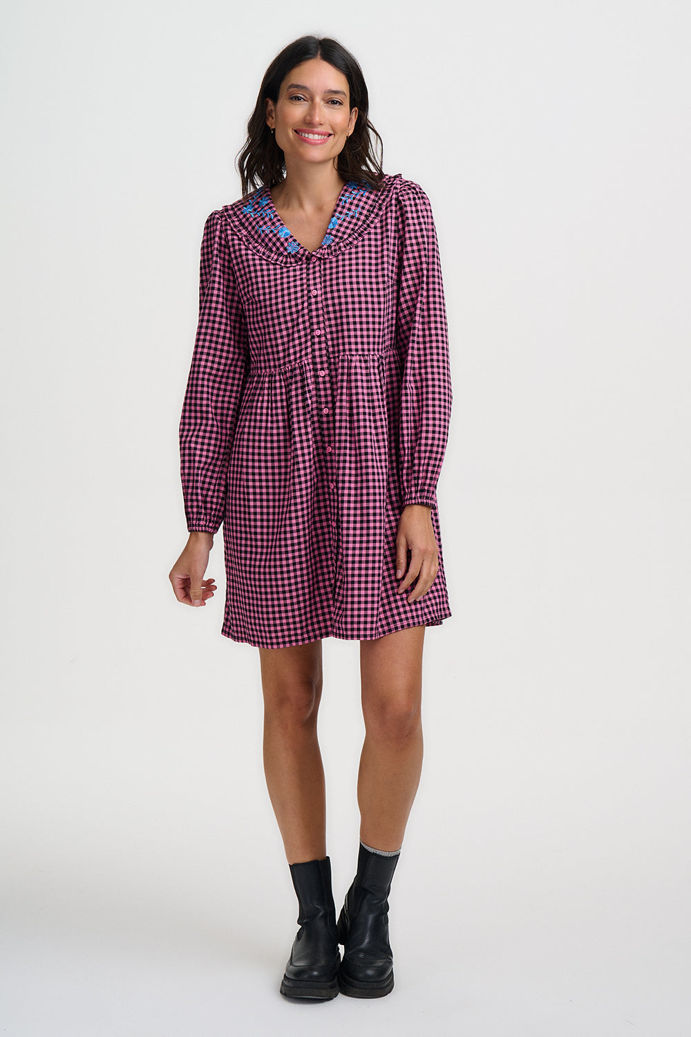 Woman wearing a checkered dress on a white background