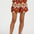 Person wearing patterned shorts on a white background