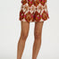 Person wearing patterned shorts on a white background