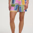 Person wearing colorful patterned shorts on a white background