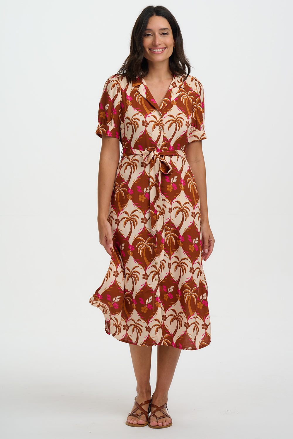 Woman wearing a patterned dress on a white background