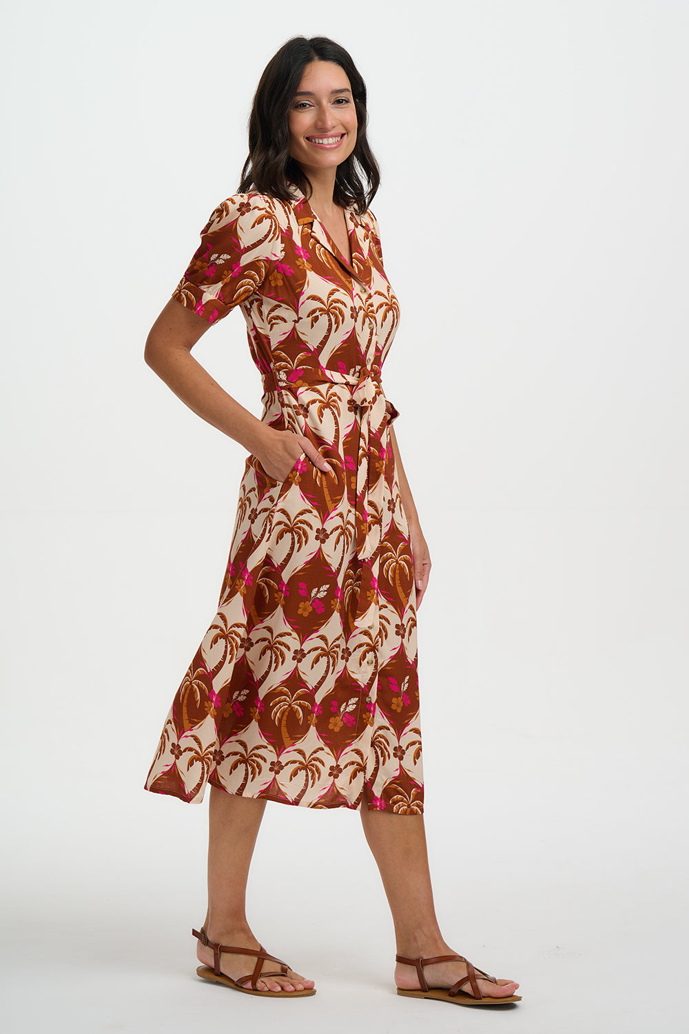 Woman wearing a patterned dress on a white background