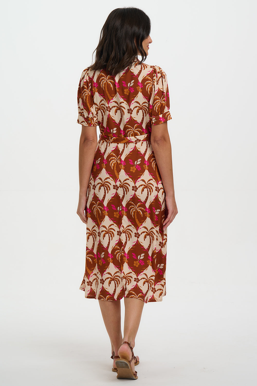 Woman wearing a patterned dress on a white background