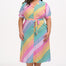 A model wearing a midi length shirt dress with a rainbow checkerboard pattern, featuring a lapel collar and puff sleeves.