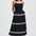Woman wearing a black dress with white trim on a white background