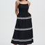 Woman wearing a black dress with white trim on a white background