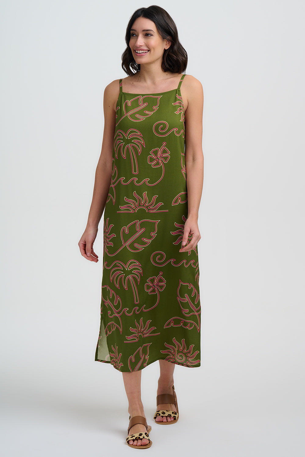 Woman wearing a green dress with floral pattern on a white background