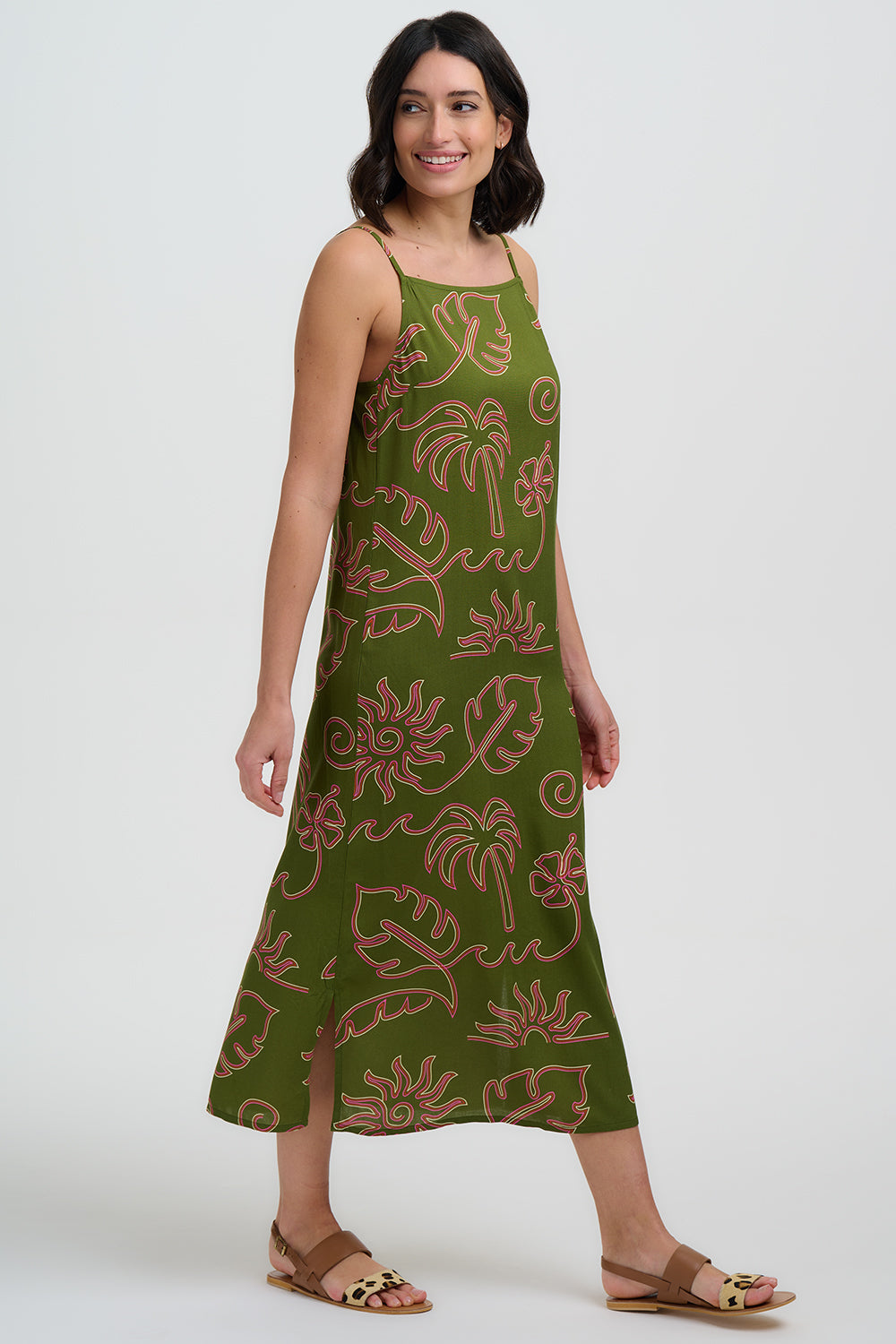 Woman wearing a green dress with floral pattern on a white background