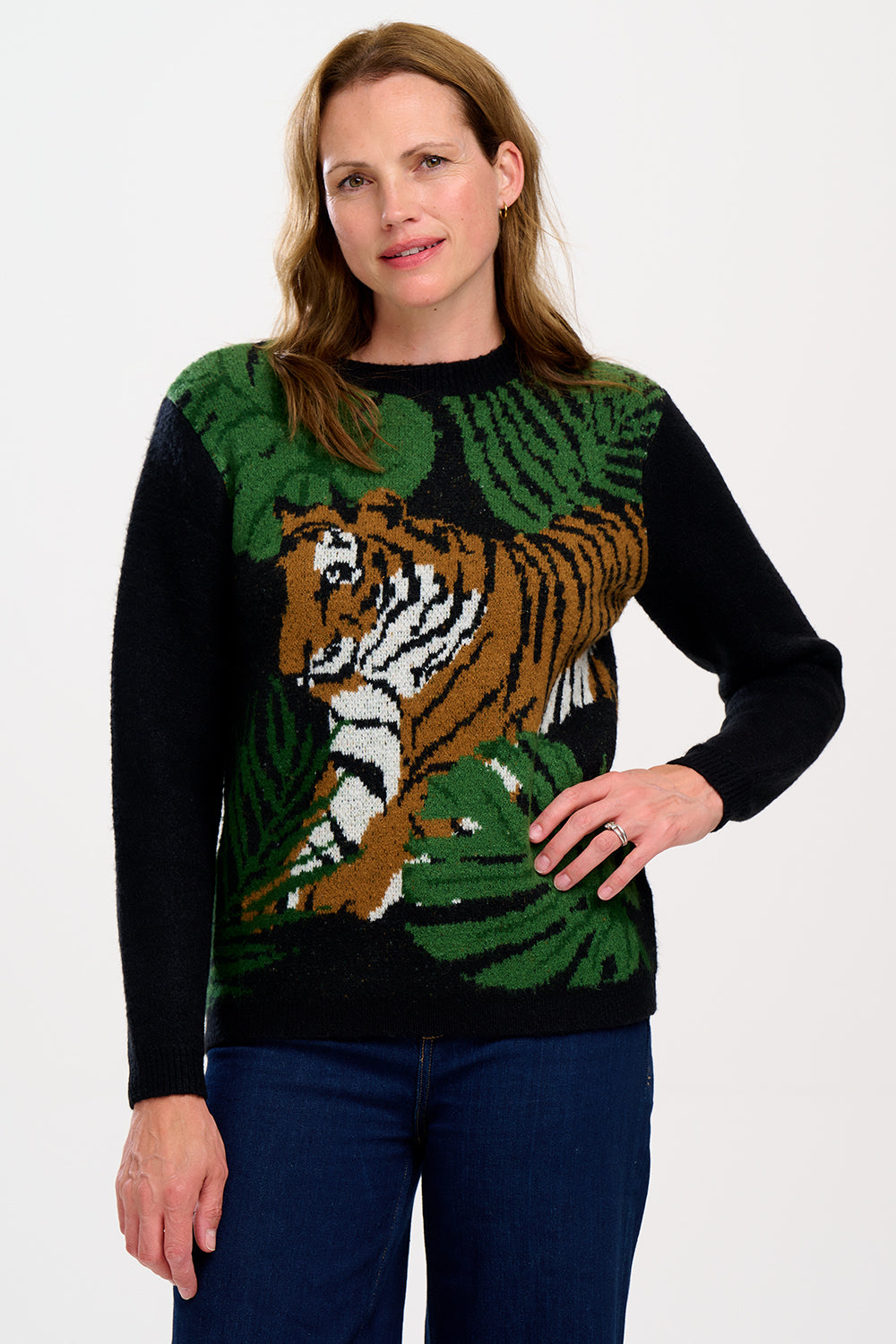 A woman  wearing a black, tiger, and palm design jumpers with a crew neck and long sleeves.