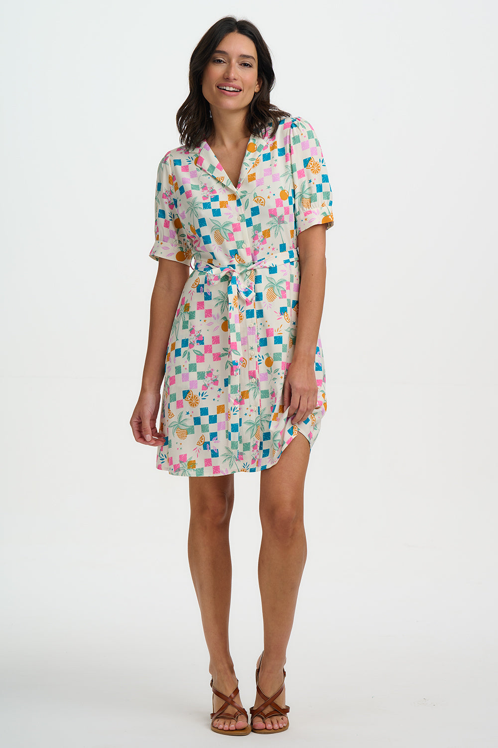 Woman wearing a colorful geometric patterned dress on a white background