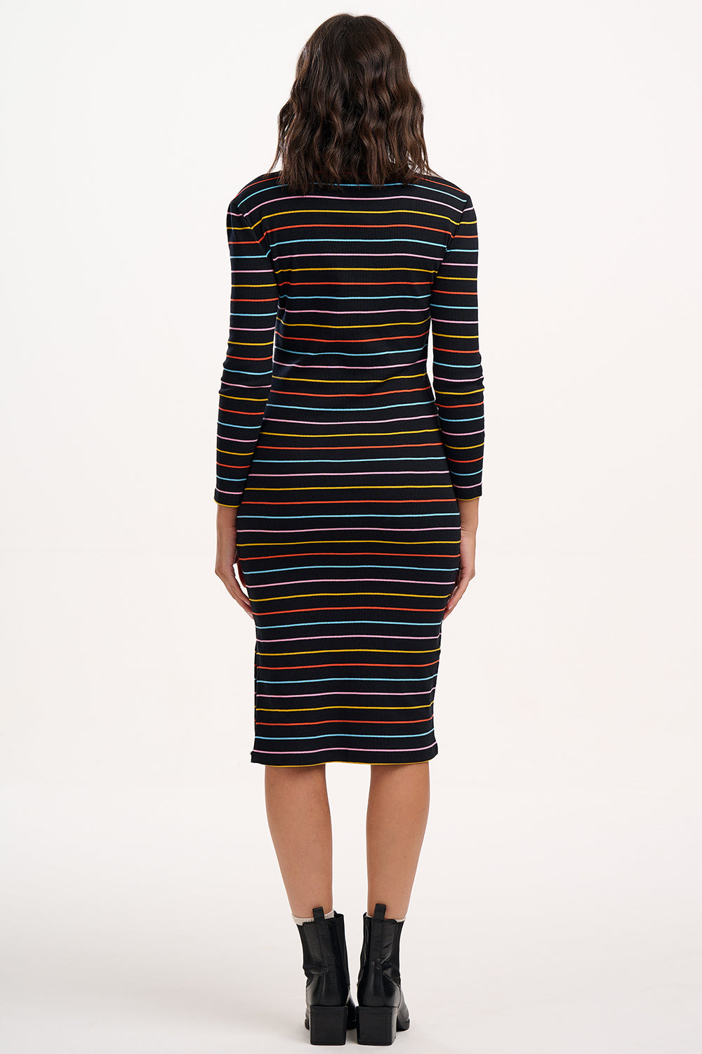 Woman wearing a striped dress with a plain background