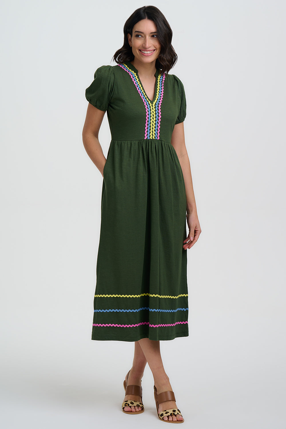 Green dress with colorful embroidery on a white background