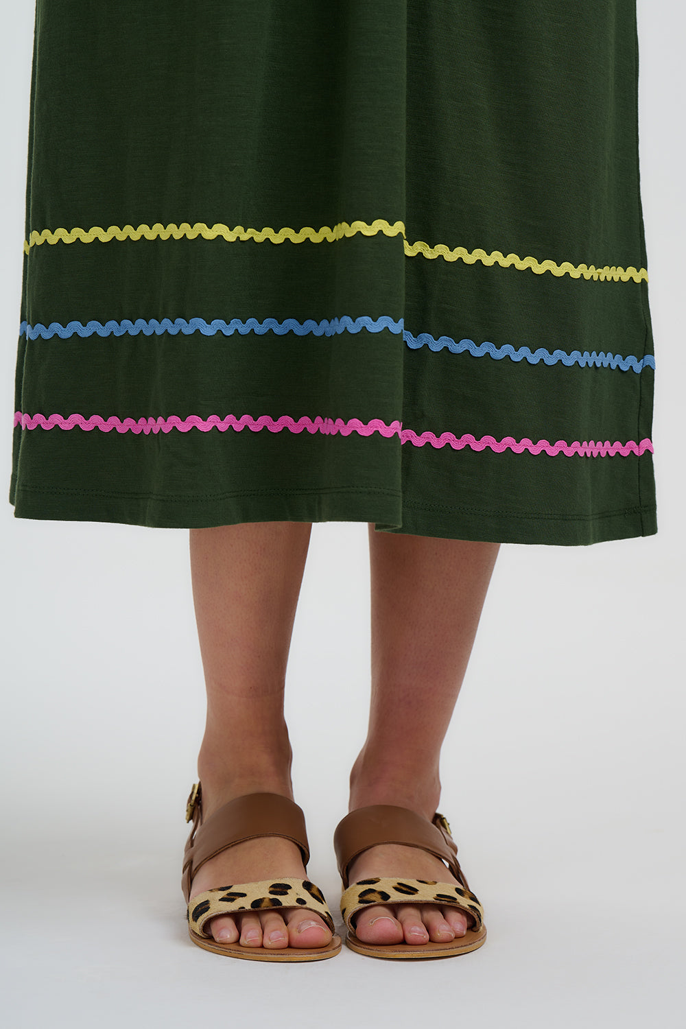 Green dress with colorful embroidery on a white background