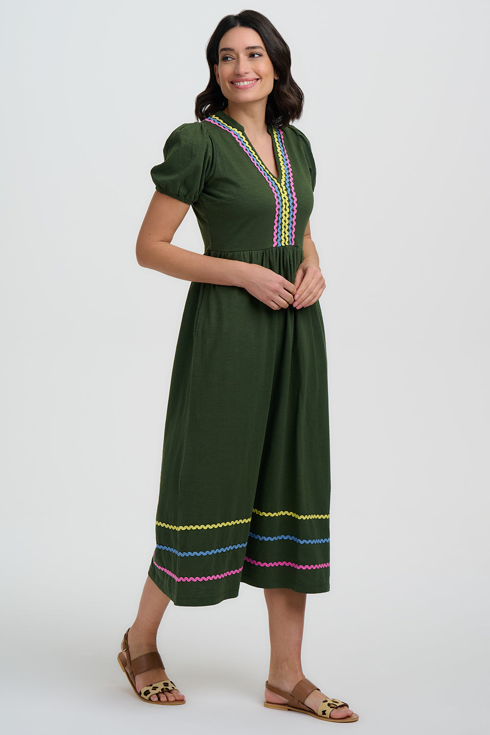 Green dress with colorful embroidery on a white background