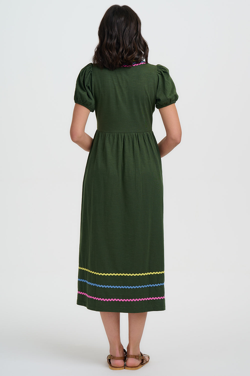 Green dress with colorful embroidery on a white background
