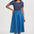 Woman wearing a blue dress with a striped top on a white background