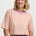 Woman wearing a striped shirt with a plain background
