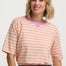 Woman wearing a striped shirt with a plain background