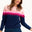 Sugarhill Brighton model wearing a navy jumper with pink gradient stripes, paired with jeans, standing against a white background.