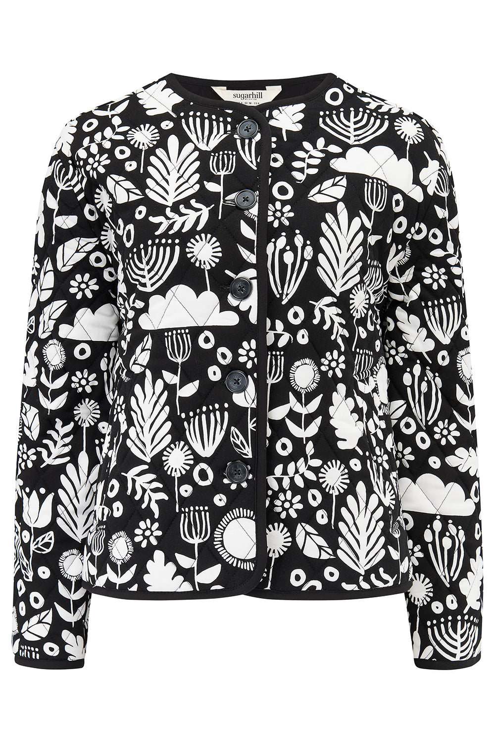 A monochrome quilted jacket with a floral folk print, featuring white leaves and flowers on a black base.