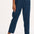 A woman modeling Romney trousers with a petrol navy color and a leopard print design.