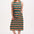 A model wearing a sleeveless, midi-length multicolor jersey dress with a wave pattern in shades of pink, green, blue, and tan.