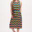 A model wearing a sleeveless, midi-length multicolor jersey dress with a wave pattern in shades of pink, green, blue, and tan.