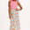 Midi-length off-white skirt with a colorful floral and hummingbird print, featuring a high waist and elasticated back.