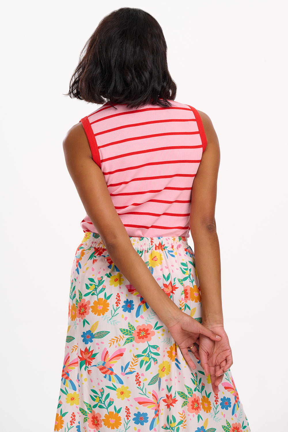 Midi-length off-white skirt with a colorful floral and hummingbird print, featuring a high waist and elasticated back.