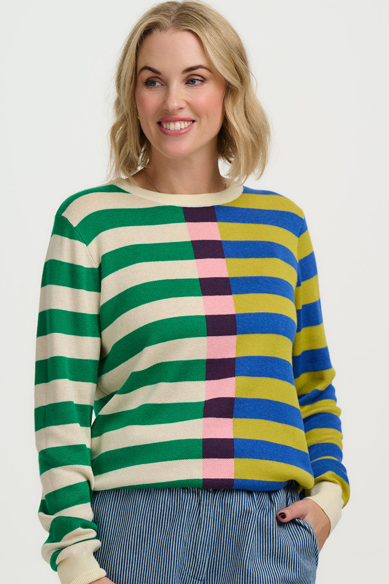 Woman wearing a colorful striped sweater on a white background