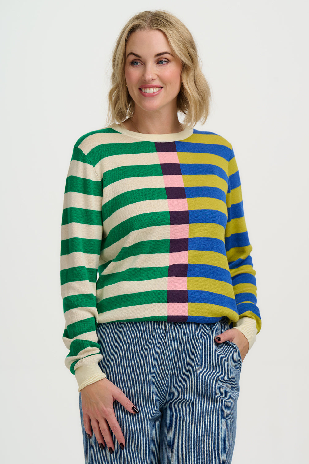 Woman wearing a colorful striped sweater on a white background