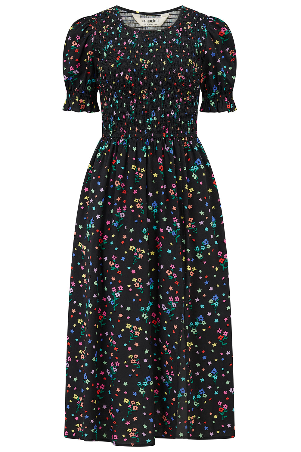 A model wearing a black midi dress with a rainbow sprigs print, featuring colorful ditsy flowers and stars, with a shirred bodice, elasticated puff sleeves, and a split hem.