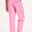 A model wearing pink Rowan trousers with a triple star pattern, paired with a striped top, standing against a white background.