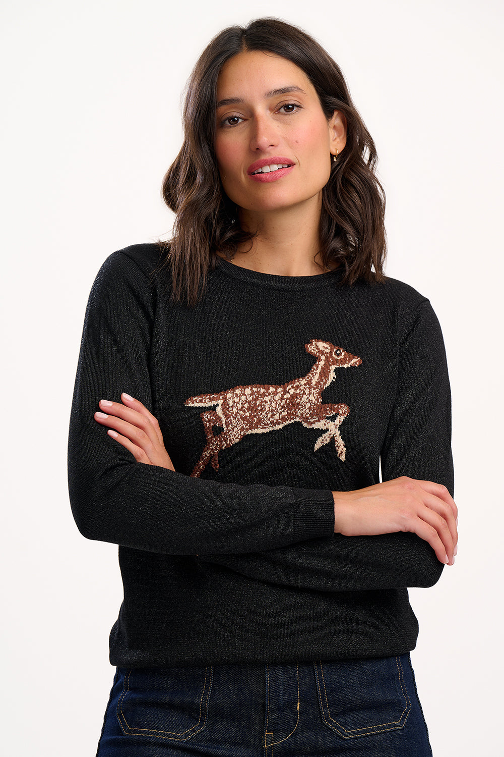Woman wearing a black sweater with a deer design on a white background