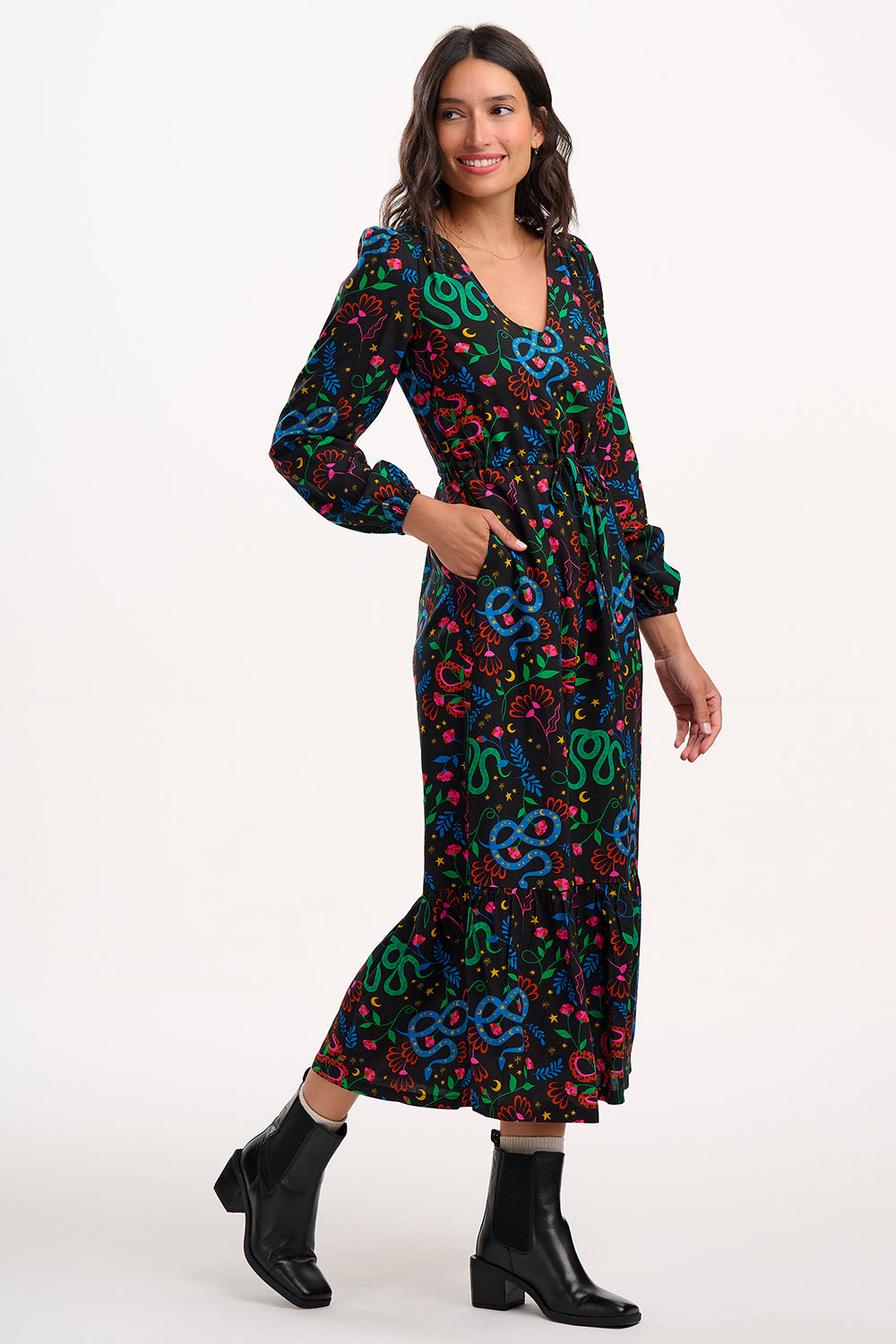 Woman wearing a colorful patterned dress on a white background