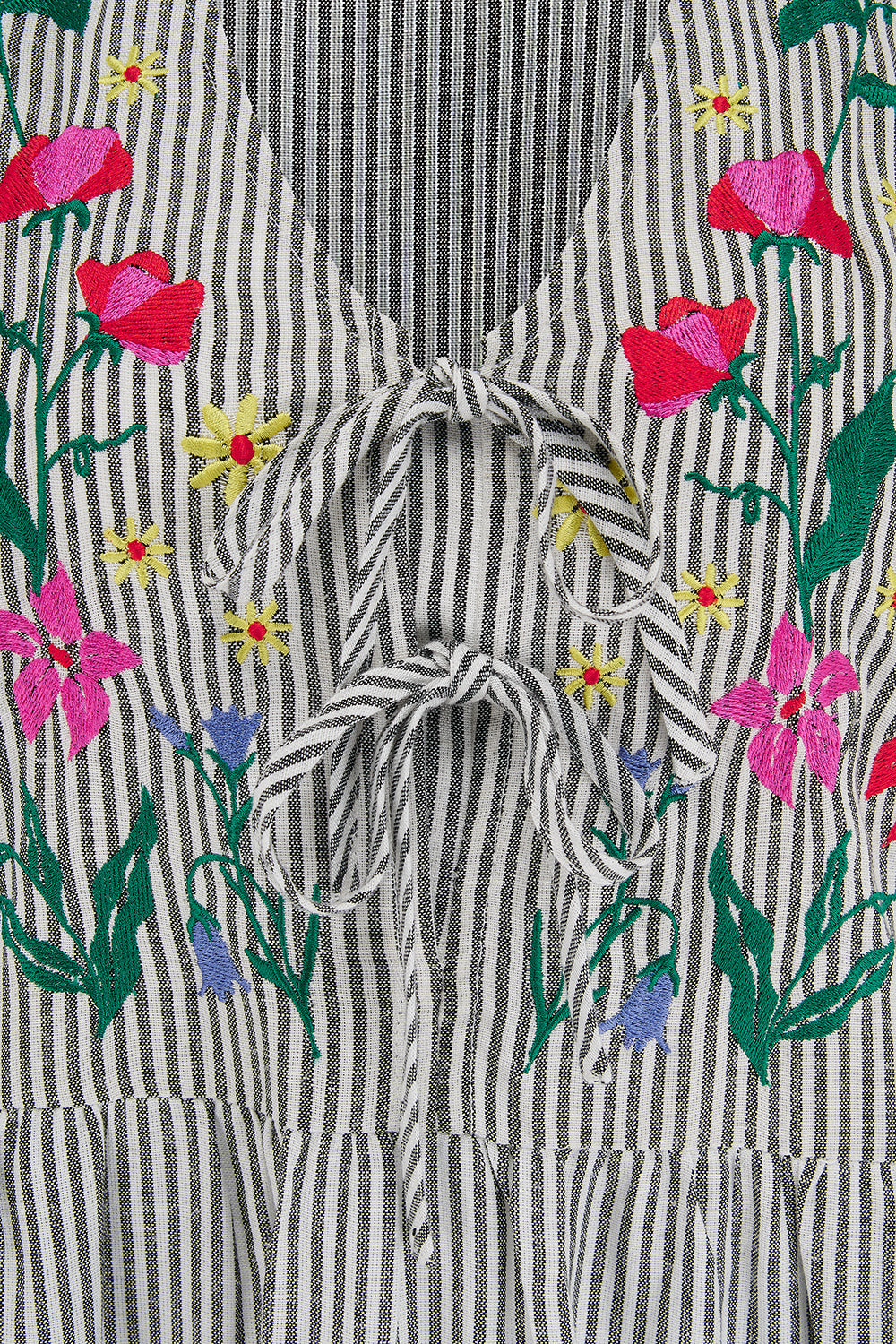 Striped dress with floral embroidery on a floral background