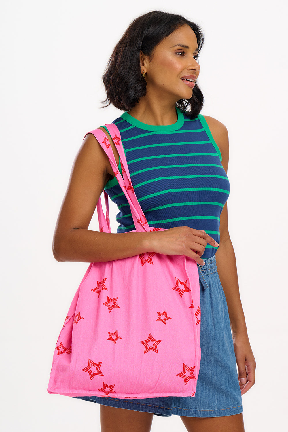 A woman wearing a sleeveless fitted vest top with blue and green horizontal stripes.
