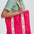 Person holding a pink tote bag with 'sugarhill' branding on a white background