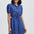 Woman wearing a blue checkered dress on a white background