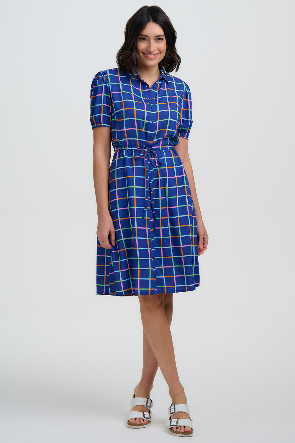 Woman wearing a blue checkered dress on a white background