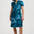 Woman wearing a blue dress with black patterns on a white background