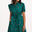 Sugarhill Brighton model wearing a green dress with colourful polka dots on a white background