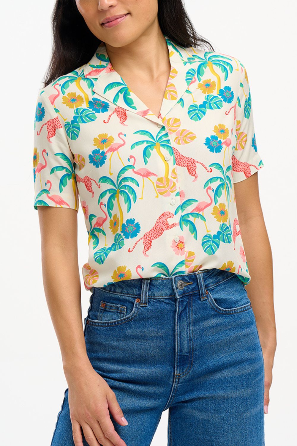 A woman wearing an off-white Santana shirt with a colorful jungle print, featuring short sleeves and a revere collar.