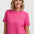 Woman wearing a pink t-shirt with a sun design on a white background