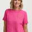 Woman wearing a pink t-shirt with a sun design on a white background
